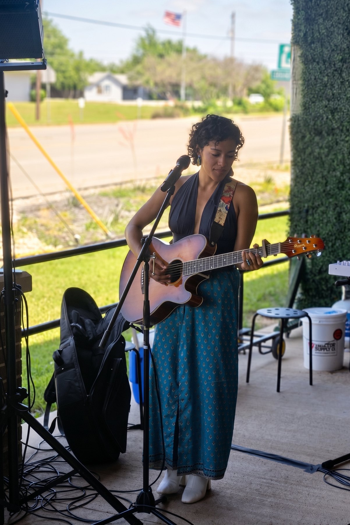 Ixchel Dion performing live with acoustic guitar